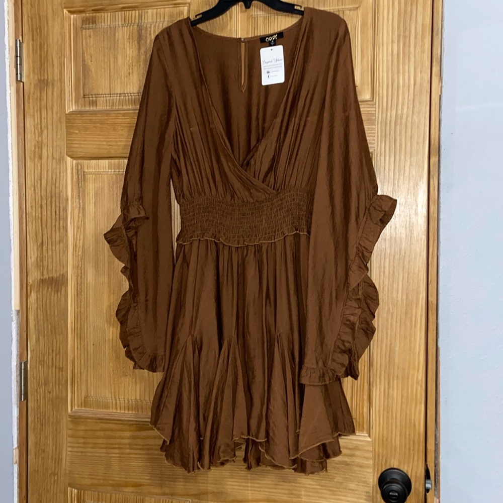 Never worn. V cut dress, flares at the arms